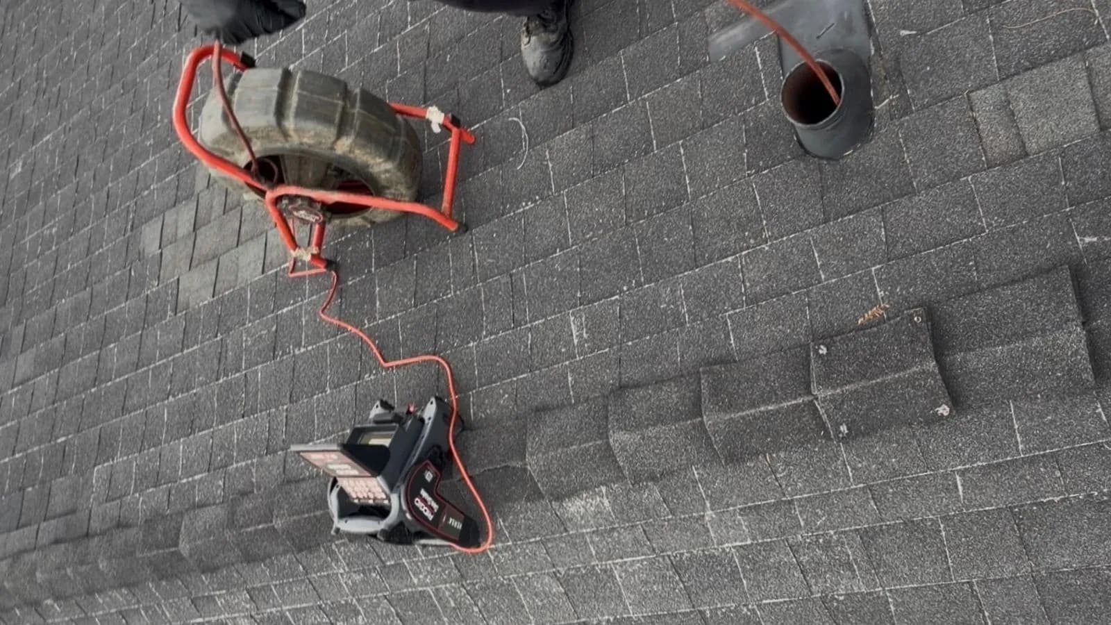 Plumber running a sewer camera from the roof vent stack at a Burbank residential property to locate a hidden cleanout