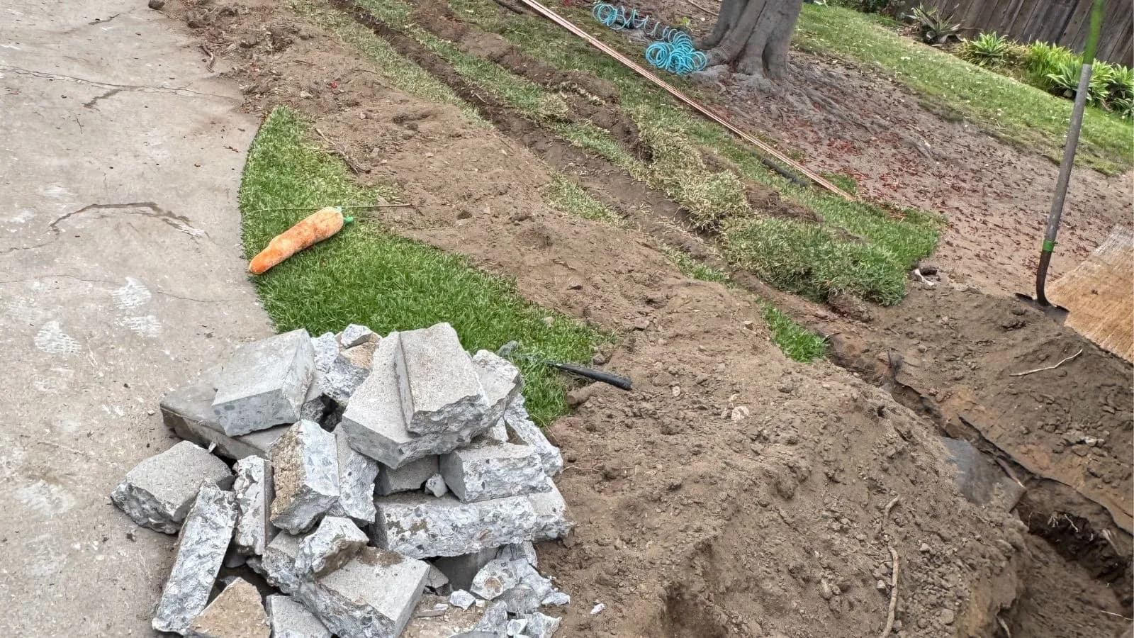 La Crescenta main water service line before replacement – driveway and yard excavation exposing failing water line